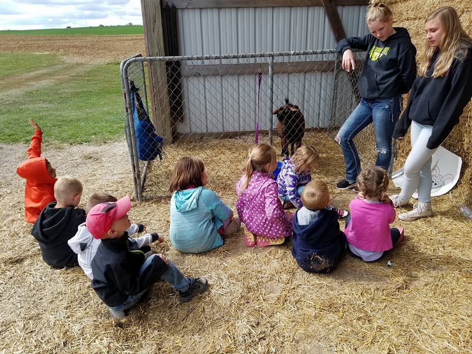Zielanis Elementary School kindergartners sitting by a goat